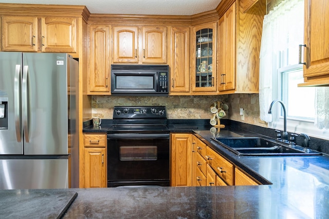 4619 Lake Haven Dr, Chattanooga, TN 37416 - kitchen featuring black appliances, glass insert cabinets, backsplash, dark countertops, and brown cabinetry
