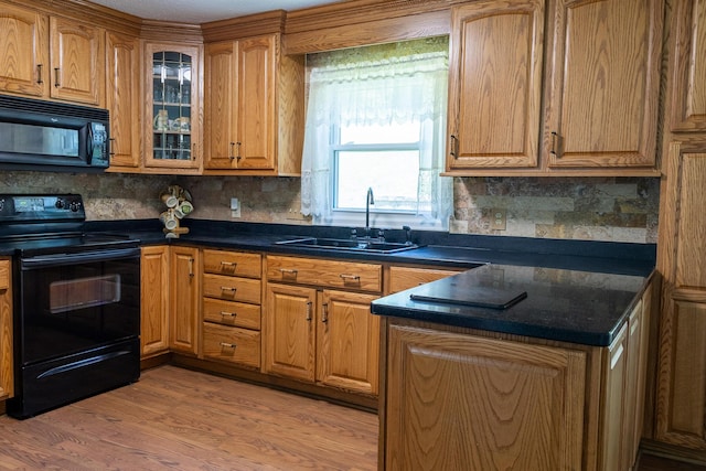 4619 Lake Haven Dr, Chattanooga, TN 37416 - kitchen featuring black appliances, light wood-style flooring, backsplash, and brown cabinetry