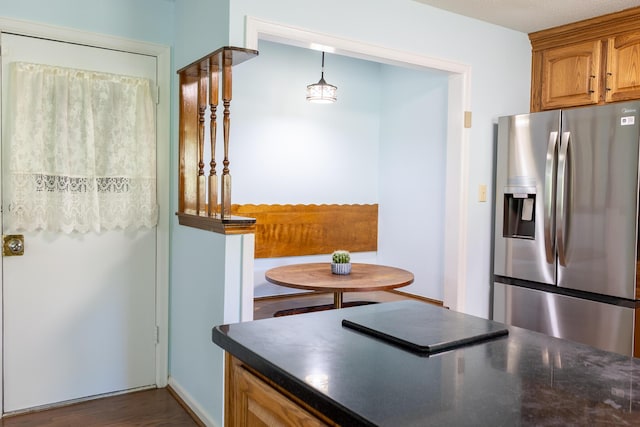 4619 Lake Haven Dr, Chattanooga, TN 37416 - kitchen with stainless steel refrigerator with ice dispenser, dark countertops, brown cabinetry, and dark wood finished floors