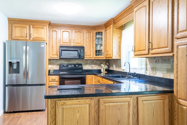 4619 Lake Haven Dr, Chattanooga, TN 37416 - kitchen featuring black appliances, glass insert cabinets, a peninsula, and decorative backsplash