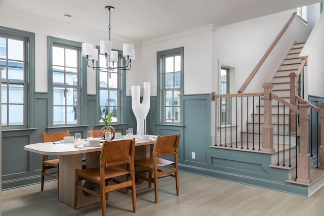 1399 Little Sorrel Rd Unit 30, Hixson, TN 37343 - dining area featuring a decorative wall, wood finished floors, stairway, a chandelier, and ornamental molding