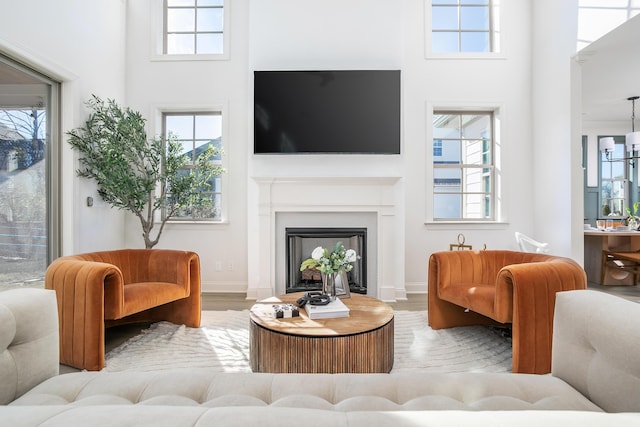 1399 Little Sorrel Rd Unit 30, Hixson, TN 37343 - living room featuring a towering ceiling, wood finished floors, healthy amount of natural light, and a fireplace