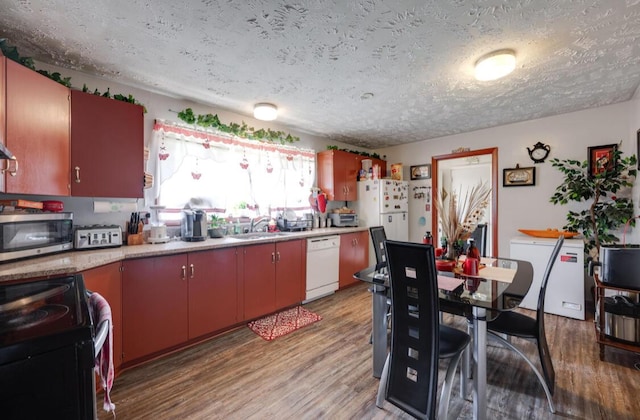1339 Woodmore Ln, Chattanooga, TN 37411 - kitchen featuring white appliances, a textured ceiling, light wood-style flooring, and light countertops
