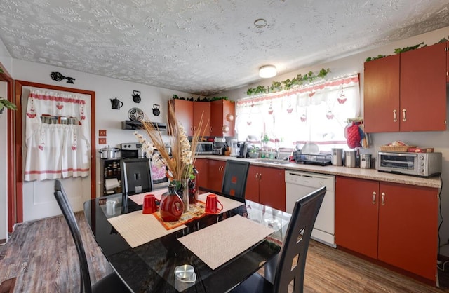 1339 Woodmore Ln, Chattanooga, TN 37411 - kitchen with dishwasher, a textured ceiling, wood finished floors, light countertops, and stainless steel microwave