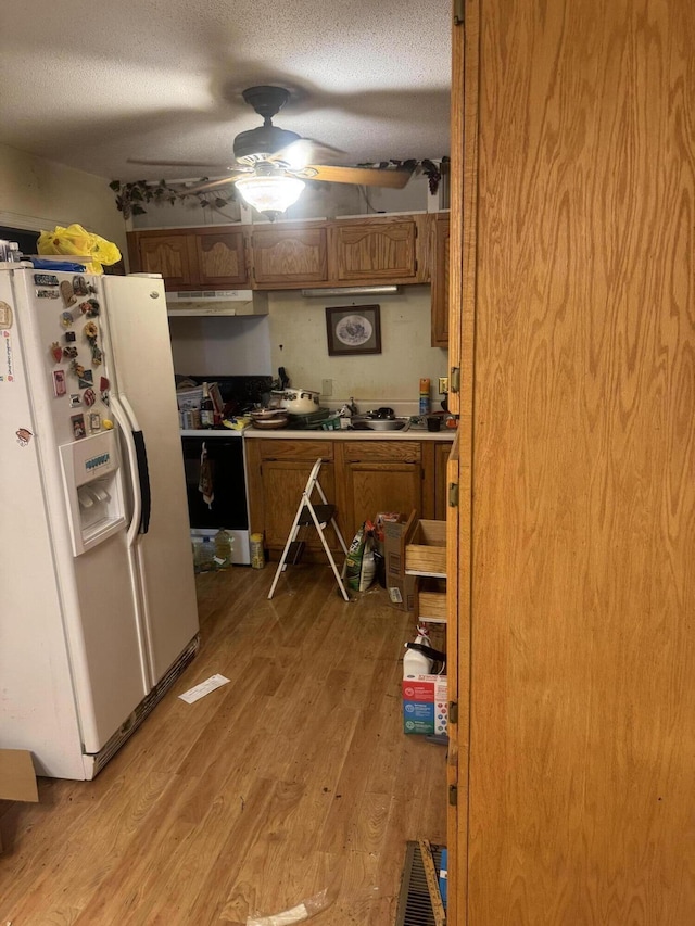 3024 Lightfoot Mill Rd, Chattanooga, TN 37406 - kitchen featuring white fridge with ice dispenser, under cabinet range hood, brown cabinetry, light wood-style floors, and a ceiling fan