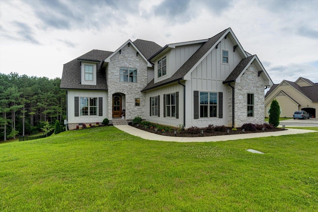 12951 Blakeslee Dr, Soddy Daisy, TN 37379 - view of front facade featuring board and batten siding, stone siding, a front yard, and roof with shingles