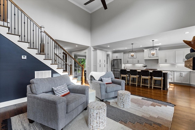 12951 Blakeslee Dr, Soddy Daisy, TN 37379 - living area with dark wood-style flooring, stairway, a ceiling fan, crown molding, and recessed lighting