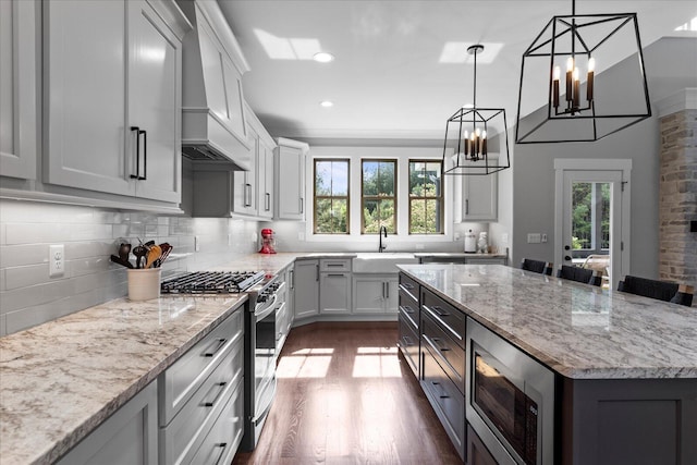 12951 Blakeslee Dr, Soddy Daisy, TN 37379 - kitchen with appliances with stainless steel finishes, plenty of natural light, custom exhaust hood, dark wood-style floors, and recessed lighting