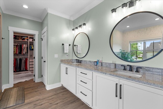 12951 Blakeslee Dr, Soddy Daisy, TN 37379 - bathroom featuring double vanity, wood finished floors, a spacious closet, recessed lighting, and crown molding