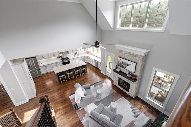 12951 Blakeslee Dr, Soddy Daisy, TN 37379 - living room featuring high vaulted ceiling, a ceiling fan, a fireplace, and dark wood-style floors