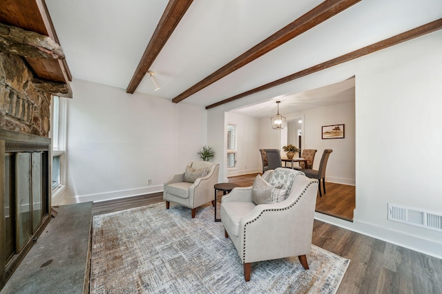 507 Big Stump Mountain Trl, Jasper, GA 30143 - living room with a large fireplace, wood finished floors, beam ceiling, and a chandelier