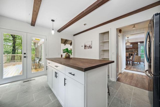 507 Big Stump Mountain Trl, Jasper, GA 30143 - kitchen with wooden counters, freestanding refrigerator, french doors, white cabinets, and beamed ceiling