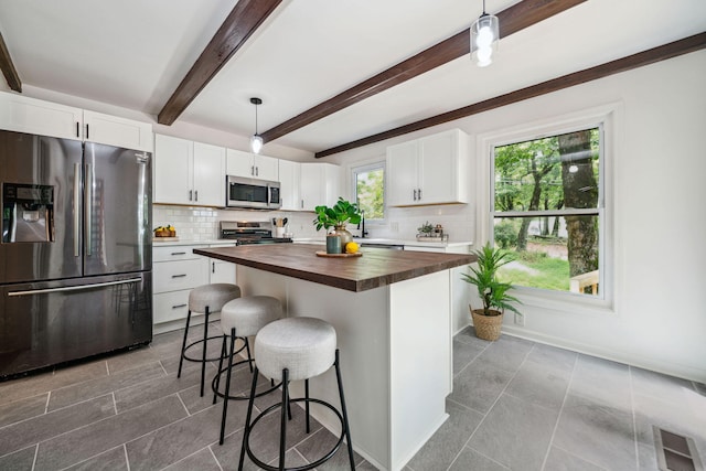507 Big Stump Mountain Trl, Jasper, GA 30143 - kitchen featuring stainless steel appliances, wooden counters, decorative backsplash, white cabinetry, and beamed ceiling