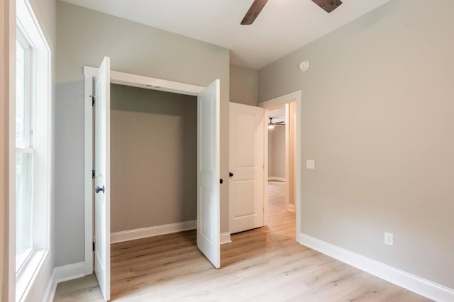 409 Hall St, Lafayette, GA 30728 - unfurnished bedroom with light wood-style floors, a closet, ceiling fan, and multiple windows