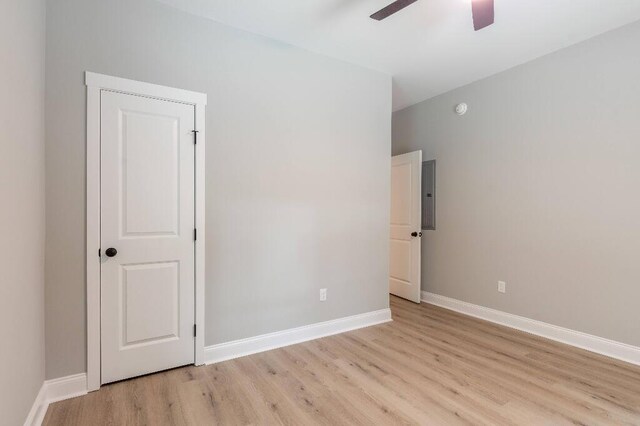 409 Hall St, Lafayette, GA 30728 - unfurnished bedroom with light wood-style flooring, electric panel, and ceiling fan