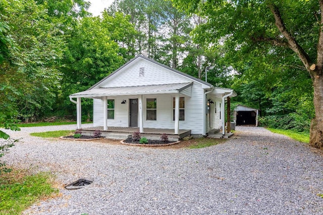 409 Hall St, Lafayette, GA 30728 - view of front of property featuring driveway, a porch, an outbuilding, and view of wooded area