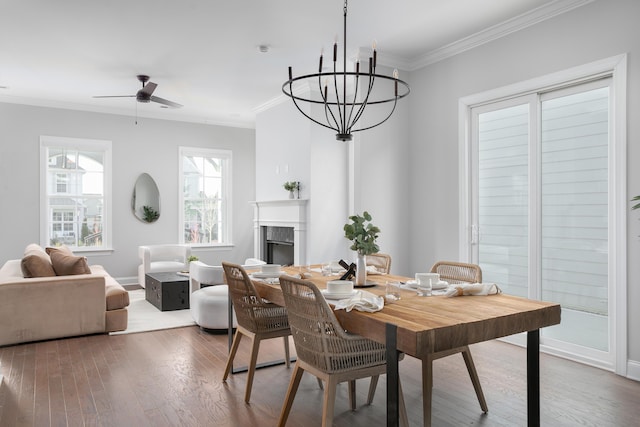 147 Honeycomb Ln, Chattanooga, TN 37421 - dining room featuring ornamental molding, a fireplace, wood finished floors, a chandelier, and a ceiling fan