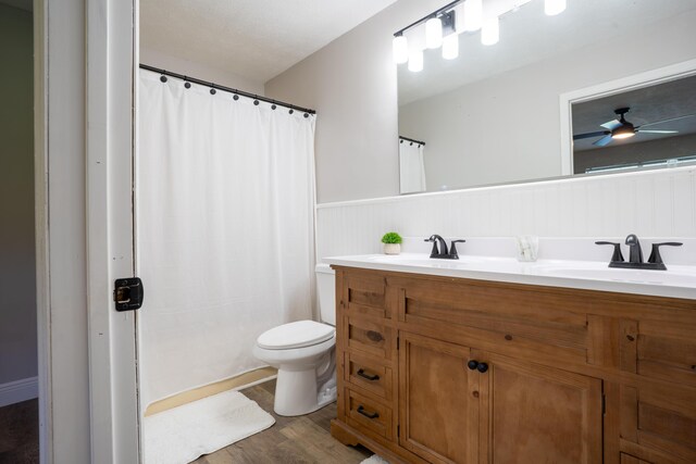 316 Old Hales Gap Rd, Trenton, GA 30752 - bathroom with wainscoting, double vanity, wood finished floors, curtained shower, and a ceiling fan