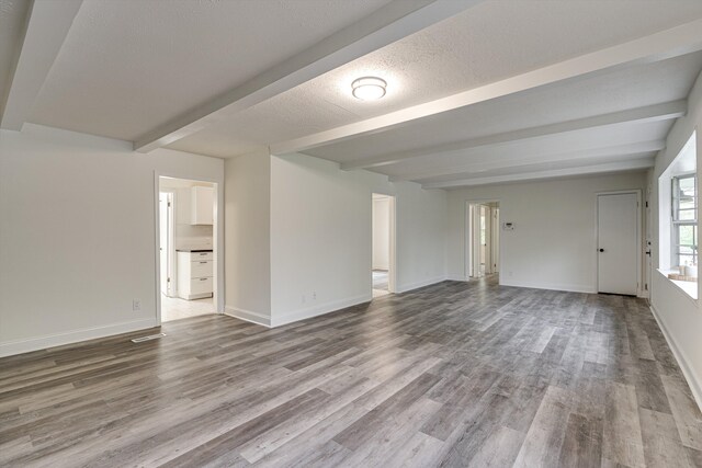 3706 Altamira Dr, Chattanooga, TN 37412 - unfurnished living room with beam ceiling and wood finished floors