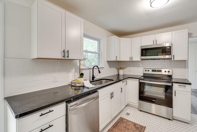 3706 Altamira Dr, Chattanooga, TN 37412 - kitchen with stainless steel appliances, white cabinets, and dark stone countertops