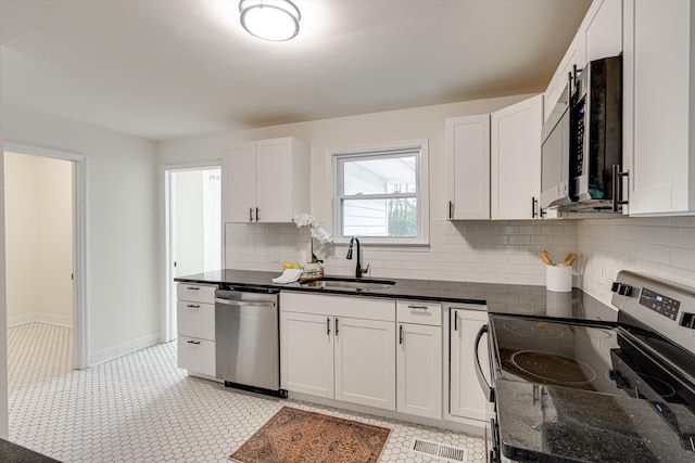 3706 Altamira Dr, Chattanooga, TN 37412 - kitchen featuring stainless steel appliances, dark stone countertops, backsplash, and white cabinets