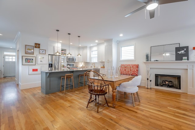 661 E 16th St, Chattanooga, TN 37408 - dining room featuring a ceiling fan, light wood finished floors, a fireplace, recessed lighting, and ornamental molding