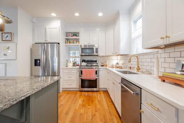 661 E 16th St, Chattanooga, TN 37408 - kitchen featuring stainless steel appliances, light wood-style floors, white cabinetry, healthy amount of natural light, and recessed lighting