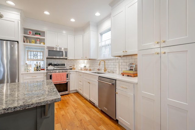 661 E 16th St, Chattanooga, TN 37408 - kitchen with appliances with stainless steel finishes, healthy amount of natural light, white cabinetry, light wood finished floors, and recessed lighting