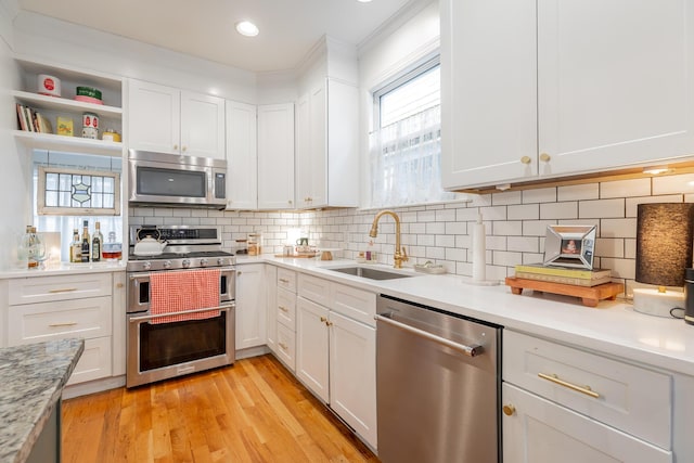 661 E 16th St, Chattanooga, TN 37408 - kitchen with appliances with stainless steel finishes, light countertops, white cabinetry, and recessed lighting