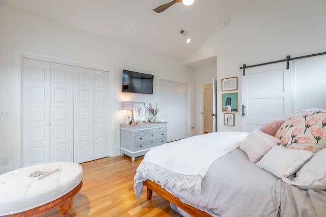 661 E 16th St, Chattanooga, TN 37408 - bedroom featuring a barn door, light wood-type flooring, high vaulted ceiling, a ceiling fan, and recessed lighting