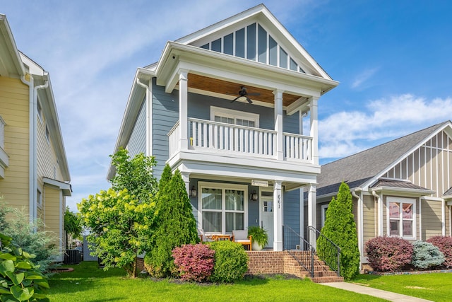 661 E 16th St, Chattanooga, TN 37408 - view of front of house with a balcony, covered porch, ceiling fan, a front yard, and board and batten siding