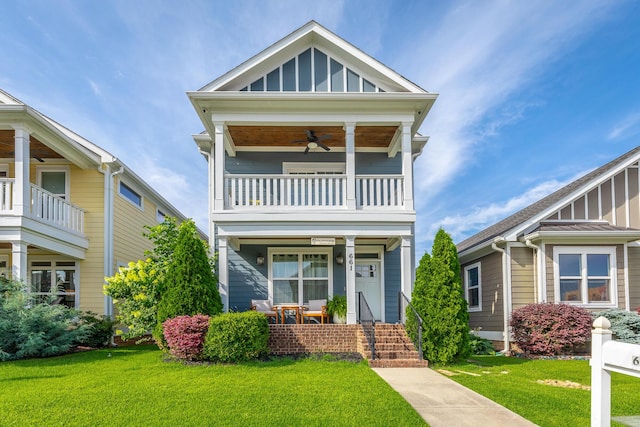 661 E 16th St, Chattanooga, TN 37408 - view of front of property featuring a balcony, covered porch, a front lawn, board and batten siding, and ceiling fan