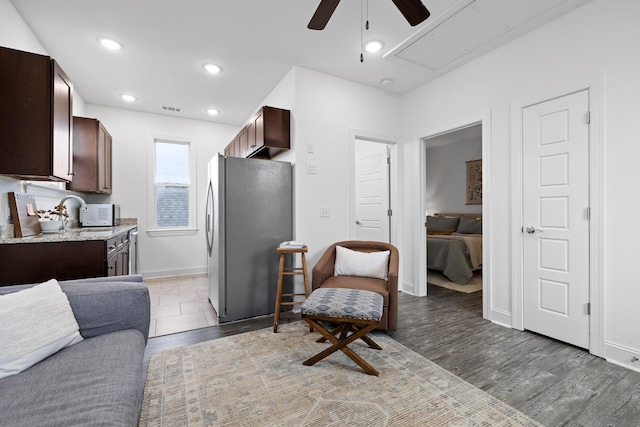 661 E 16th St, Chattanooga, TN 37408 - kitchen with freestanding refrigerator, ceiling fan, dark brown cabinetry, and open floor plan