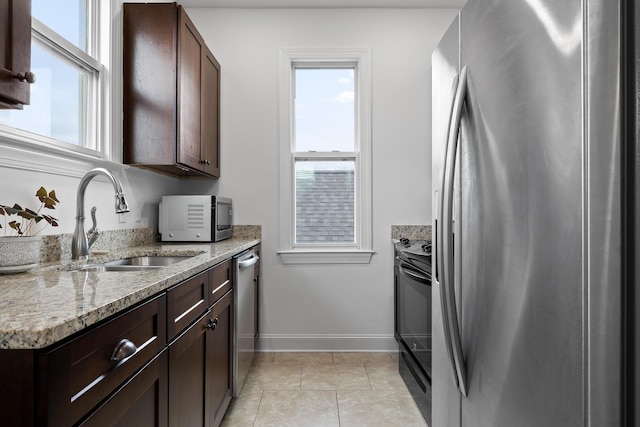 661 E 16th St, Chattanooga, TN 37408 - kitchen with stainless steel appliances, dark brown cabinetry, and plenty of natural light