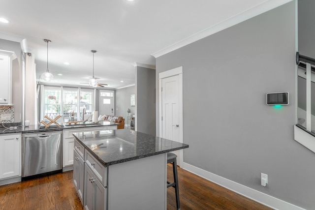 1023 Givens Rd, Chattanooga, TN 37421 - kitchen featuring dishwasher, ornamental molding, a kitchen bar, dark wood finished floors, and a ceiling fan