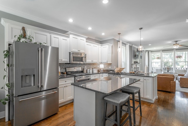 1023 Givens Rd, Chattanooga, TN 37421 - kitchen featuring stainless steel appliances, a peninsula, open floor plan, white cabinetry, and recessed lighting