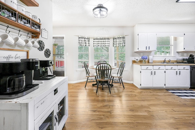 176 Ola Dr, Cohutta, GA 30710 - kitchen featuring light wood finished floors, white cabinets, a textured ceiling, dishwasher, and light countertops
