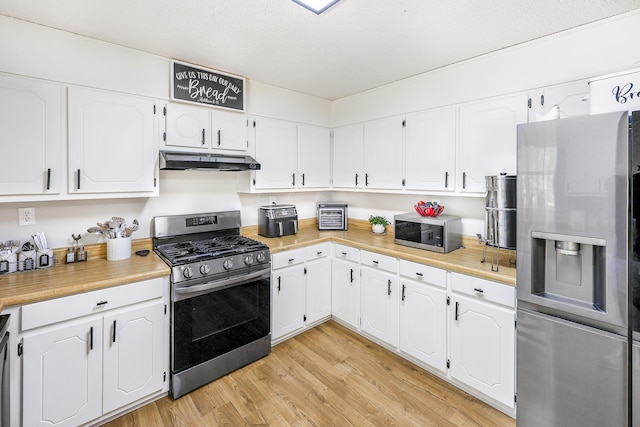 176 Ola Dr, Cohutta, GA 30710 - kitchen with appliances with stainless steel finishes, under cabinet range hood, white cabinets, and light countertops