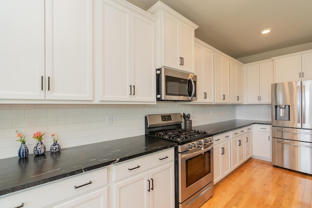 3328 Prairie Range Ln, Apison, TN 37302 - kitchen featuring appliances with stainless steel finishes, white cabinetry, dark stone countertops, and recessed lighting