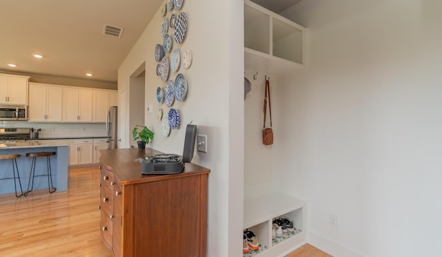 3328 Prairie Range Ln, Apison, TN 37302 - kitchen featuring stainless steel appliances, light wood-style flooring, decorative backsplash, recessed lighting, and white cabinetry