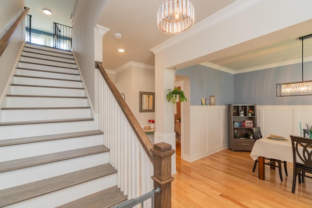 3328 Prairie Range Ln, Apison, TN 37302 - stairway with a chandelier, wood finished floors, crown molding, wainscoting, and a decorative wall