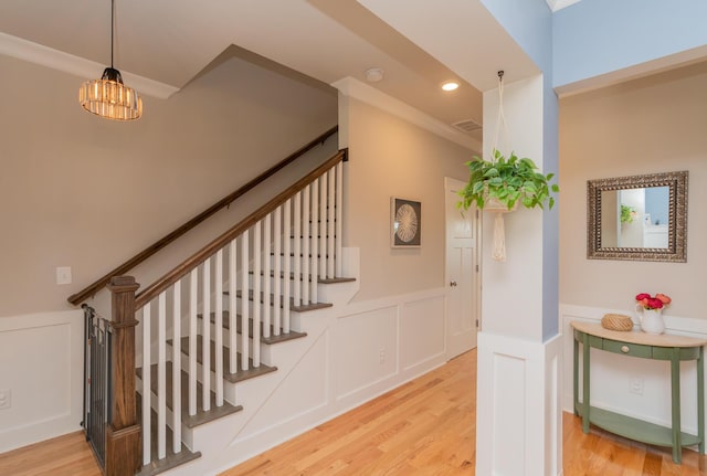 3328 Prairie Range Ln, Apison, TN 37302 - stairs featuring wainscoting, a decorative wall, wood finished floors, ornamental molding, and recessed lighting
