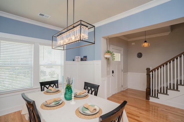 3328 Prairie Range Ln, Apison, TN 37302 - dining room featuring a chandelier, a wainscoted wall, stairway, light wood-style flooring, and ornamental molding