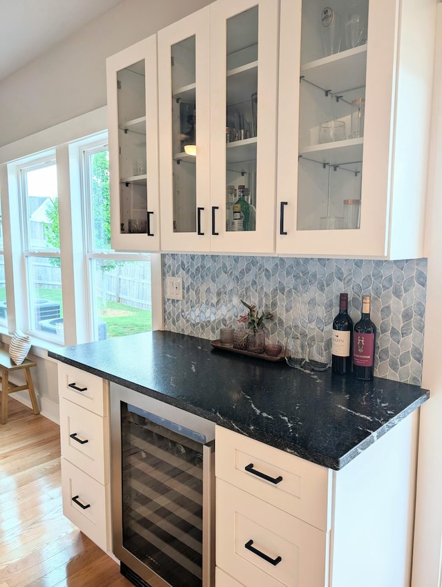 3328 Prairie Range Ln, Apison, TN 37302 - indoor dry bar with beverage cooler, light wood-style flooring, and tasteful backsplash