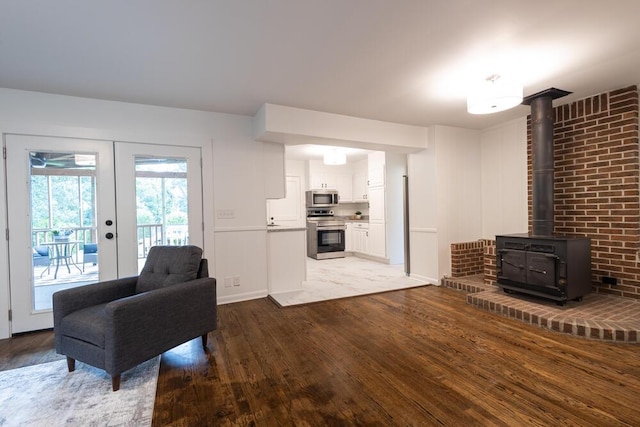 3517 Connelly Ln, Chattanooga, TN 37412 - living area with light wood-style floors, french doors, and a wood stove