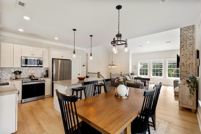 7596 Grasshopper Rd, Georgetown, TN 37336 - dining space featuring light wood finished floors, a chandelier, recessed lighting, and ornamental molding