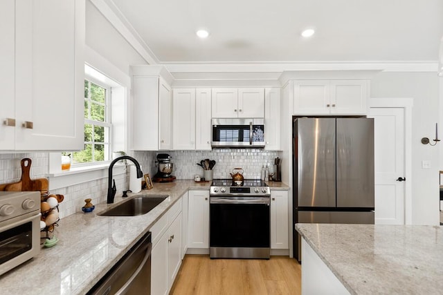 7596 Grasshopper Rd, Georgetown, TN 37336 - kitchen with appliances with stainless steel finishes, white cabinets, backsplash, light stone countertops, and recessed lighting