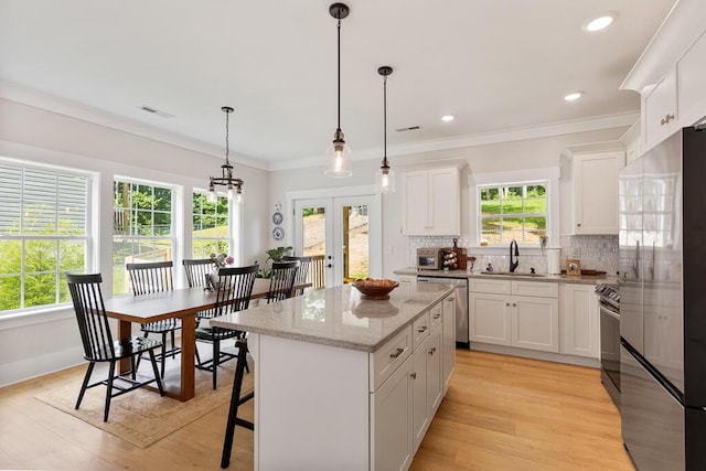 7596 Grasshopper Rd, Georgetown, TN 37336 - kitchen featuring stainless steel appliances, a center island, tasteful backsplash, french doors, and white cabinets