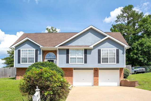 6220 Hunter Valley Rd, Ooltewah, TN 37363 - split foyer home featuring brick siding, an attached garage, concrete driveway, and a shingled roof