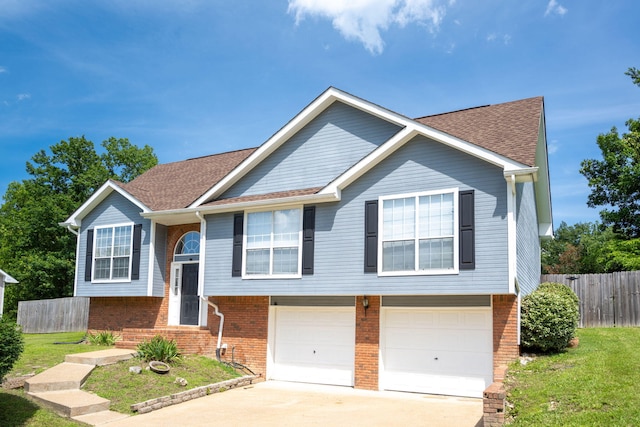 6220 Hunter Valley Rd, Ooltewah, TN 37363 - split foyer home featuring an attached garage, brick siding, driveway, and a shingled roof